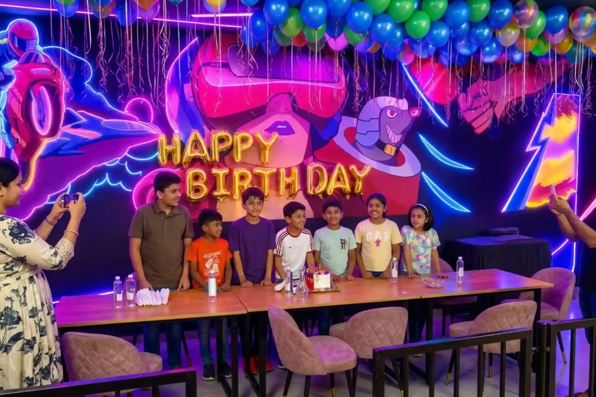 Kids birthday party with gold balloons and neon decorations at Game Xtreme