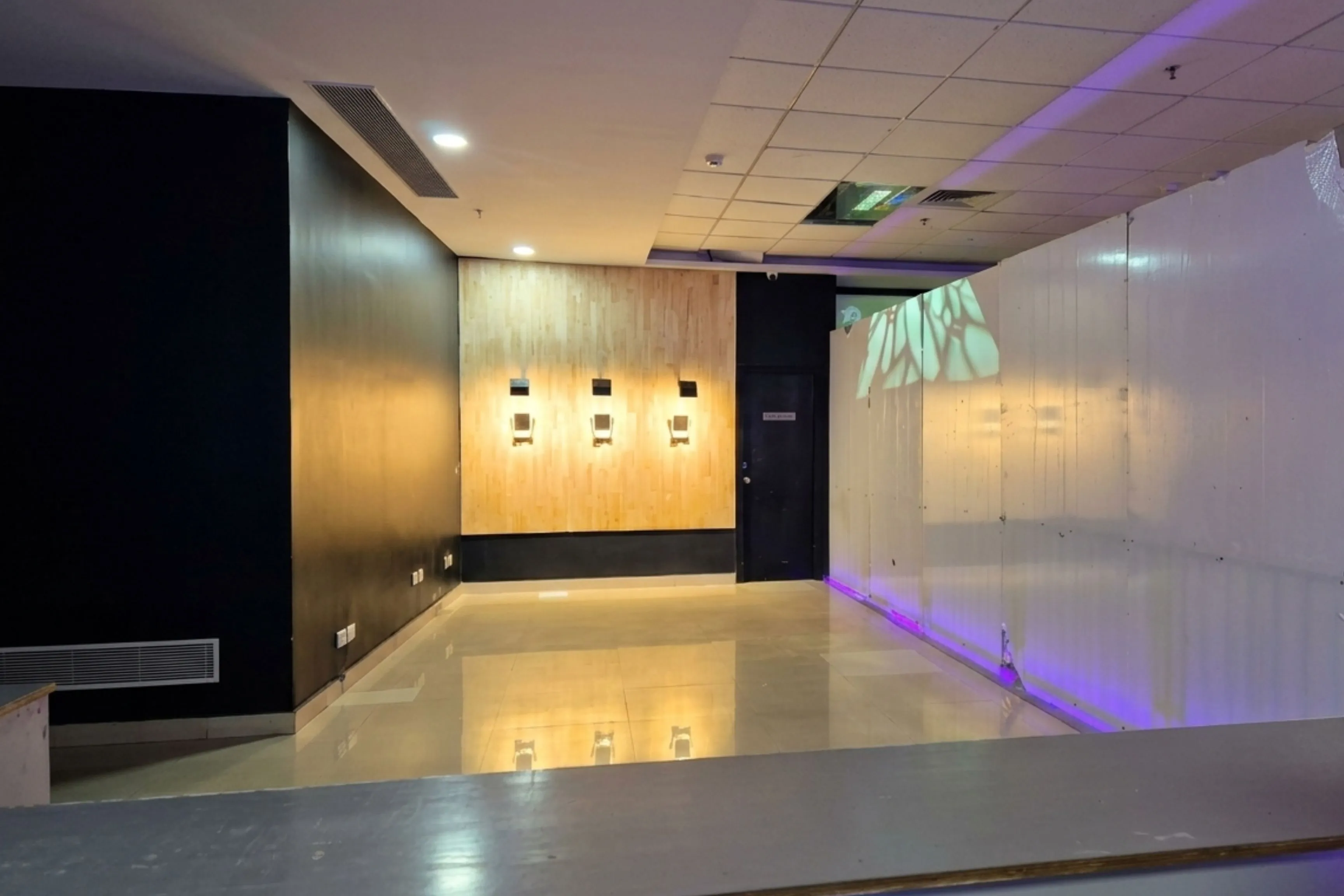 Wide view of indoor shooting range with wooden target wall at Game Xtreme