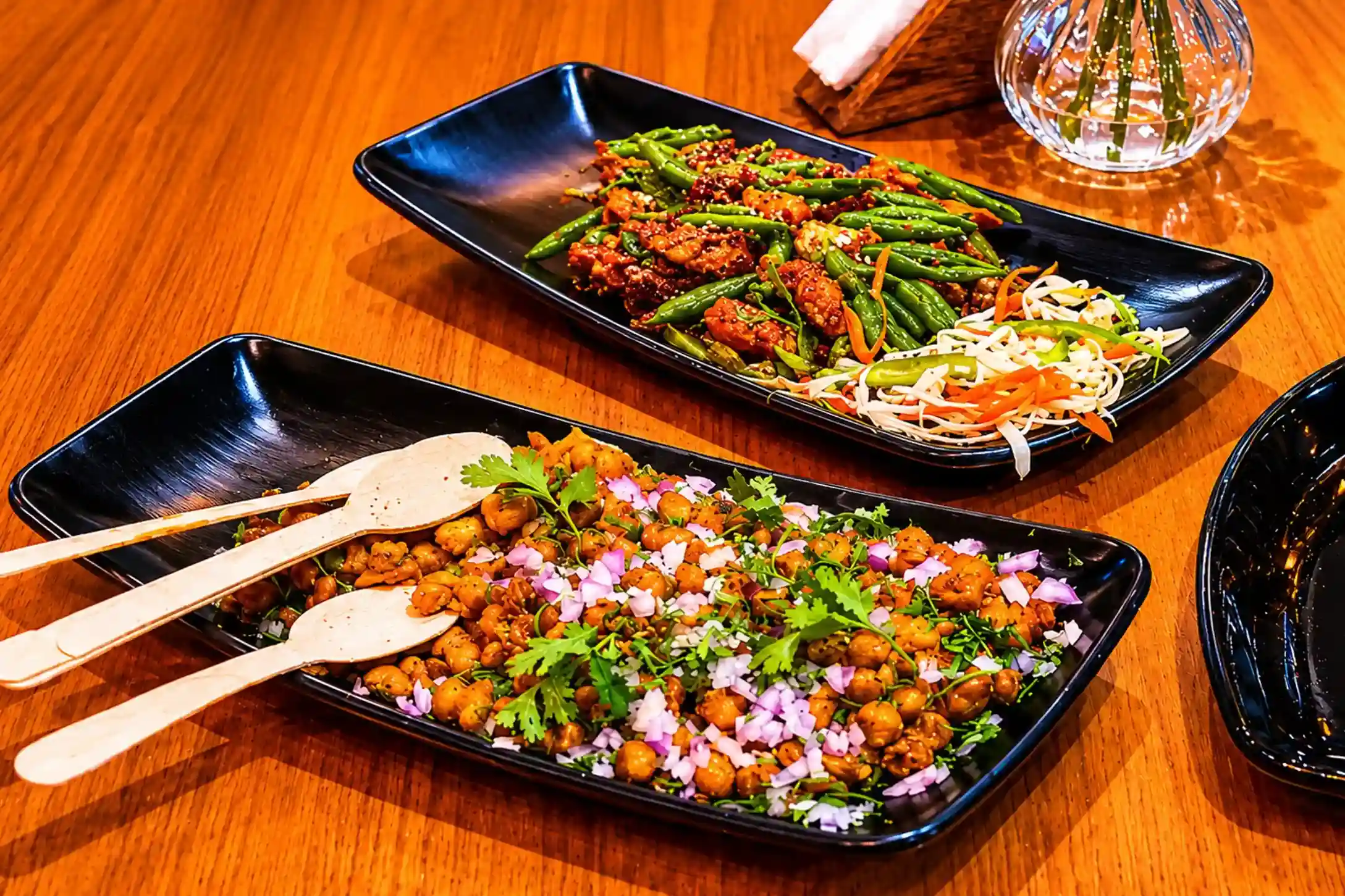 Chickpea chaat and green bean stir-fry on dark plates
