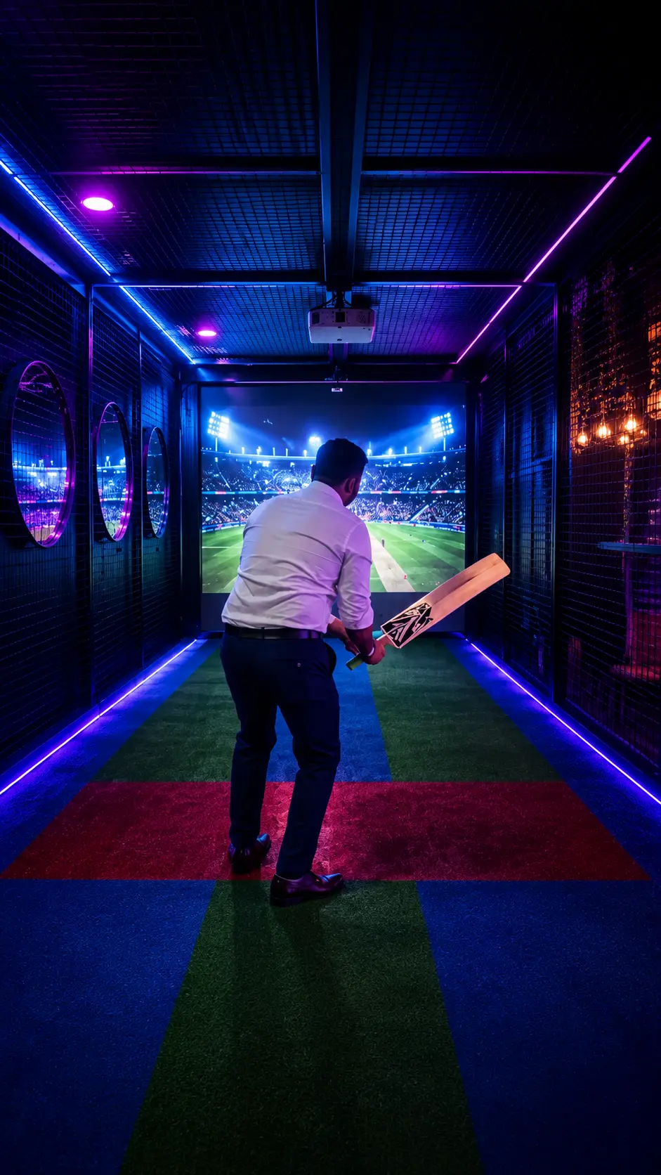 Player in batting stance facing projected stadium in neon-lit cricket simulator at Game Xtreme Hyderabad