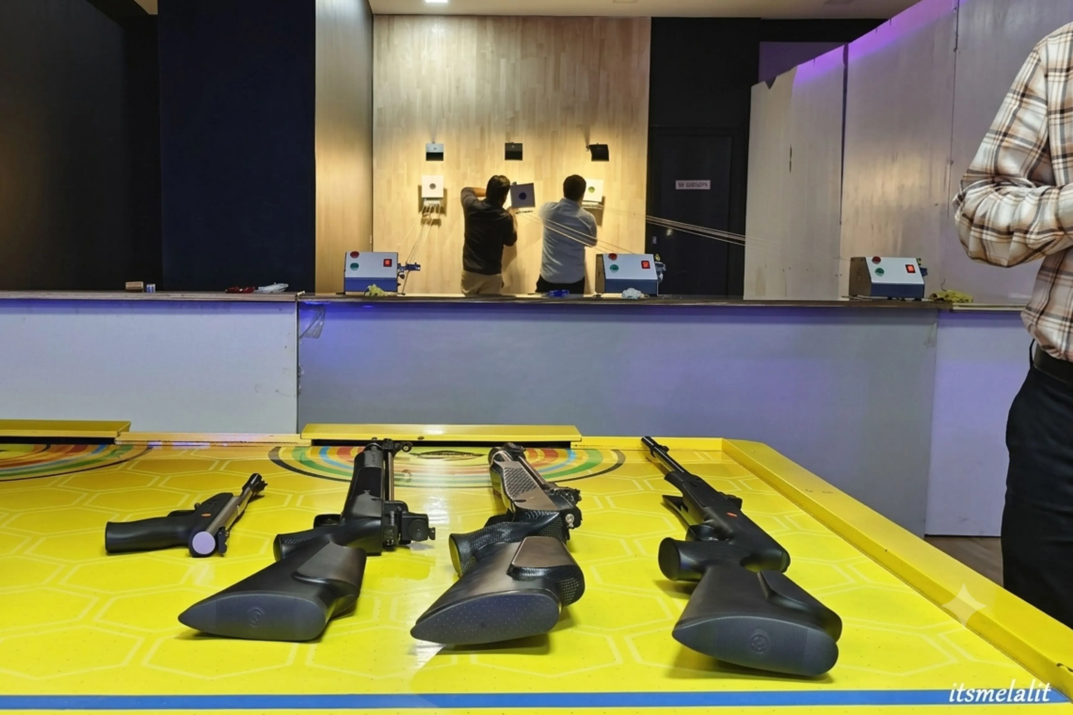 Group of friends enjoying air gun shooting at Game Xtreme
